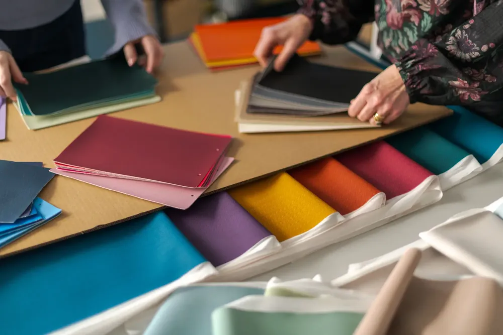 Designers looking at different colours of ambla fabrics