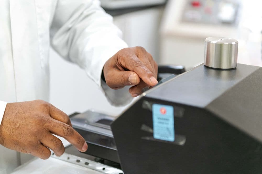 Man testing fabric on a machine